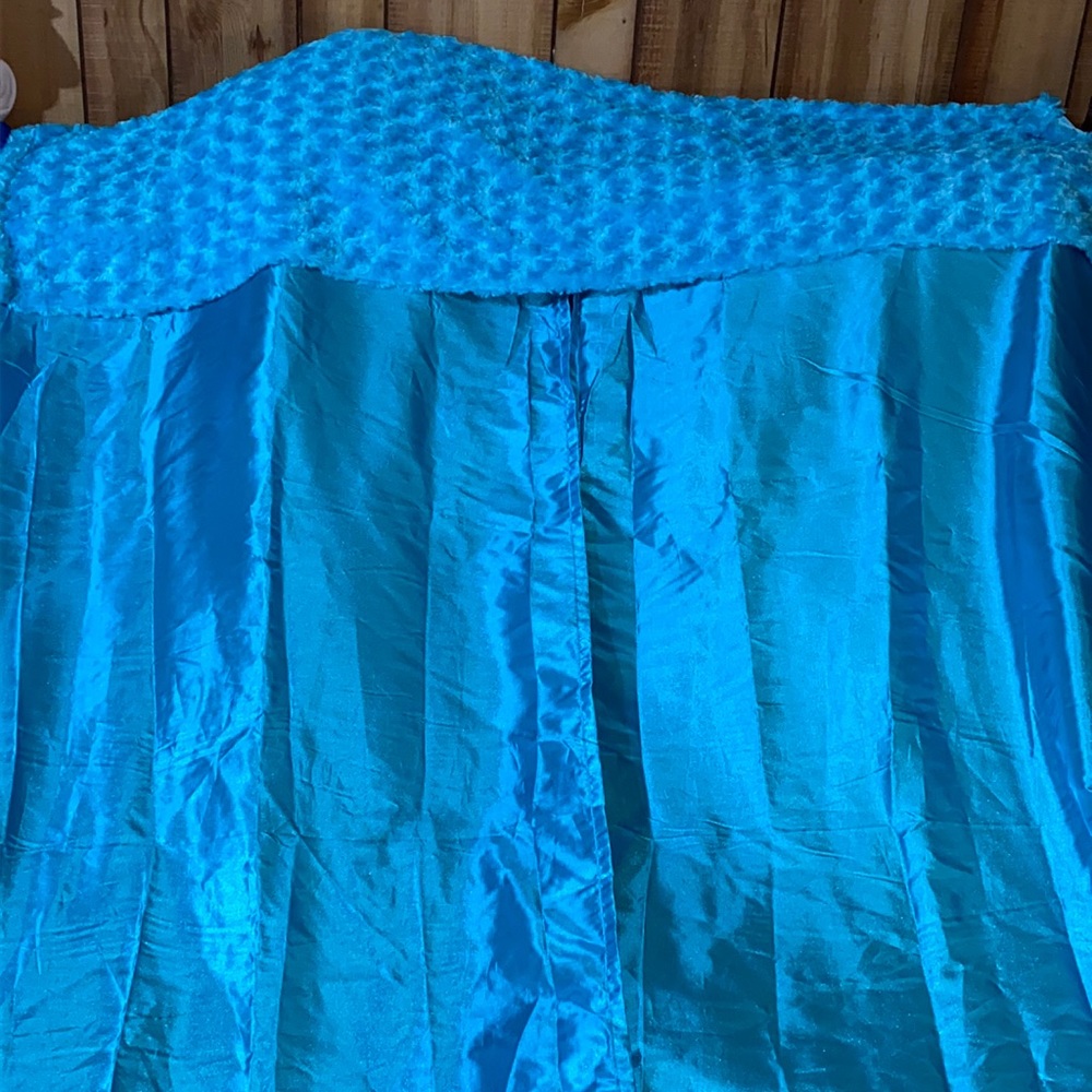 Blue shiney curtain with fuzzy balance made on top